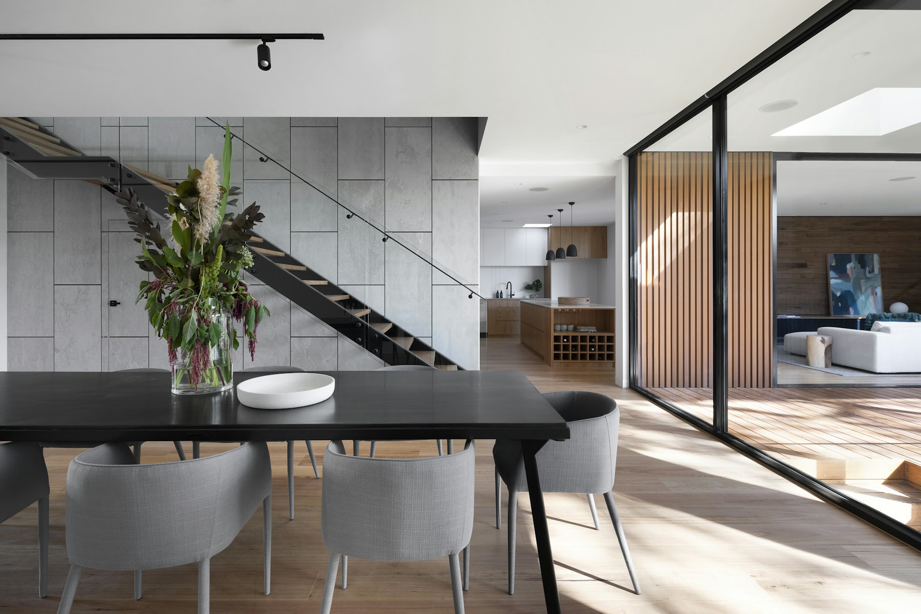 Open-plan living and dining space with natural timber and daylight